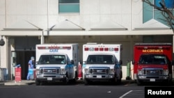 Ambulances are seen outside of St. Francis Medical Center emergency room during a surge of coronavirus disease (COVID-19) cases in Los Angeles, California, Dec. 26, 2020. 