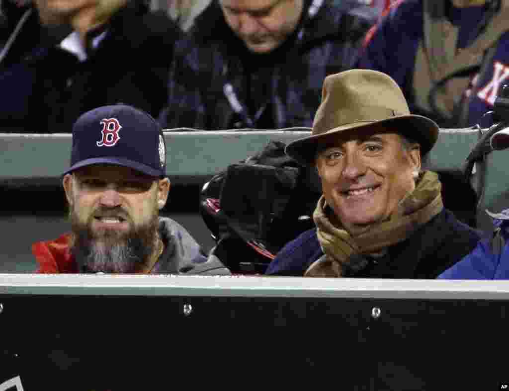 Actor Andy Garcia, right, watches alongside Boston Red Sox catcher David Ross, left, during the second inning of Game 2 of baseball's World Series between the Red Sox and the St. Louis Cardinals, Oct. 24, 2013, in Boston. 