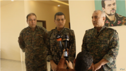 SDF general commander Mazloum Abdi, center, speaks during a press conference in Kobani, Syria, July 22, 2019. (Sirwan Kajjo/VOA video grab)