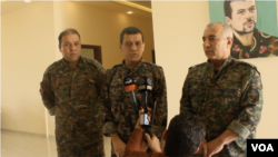 SDF general commander Mazloum Abdi, center, speaks during a press conference in Kobani, Syria, July 22, 2019. (S. Kajjo/VOA video grab)
