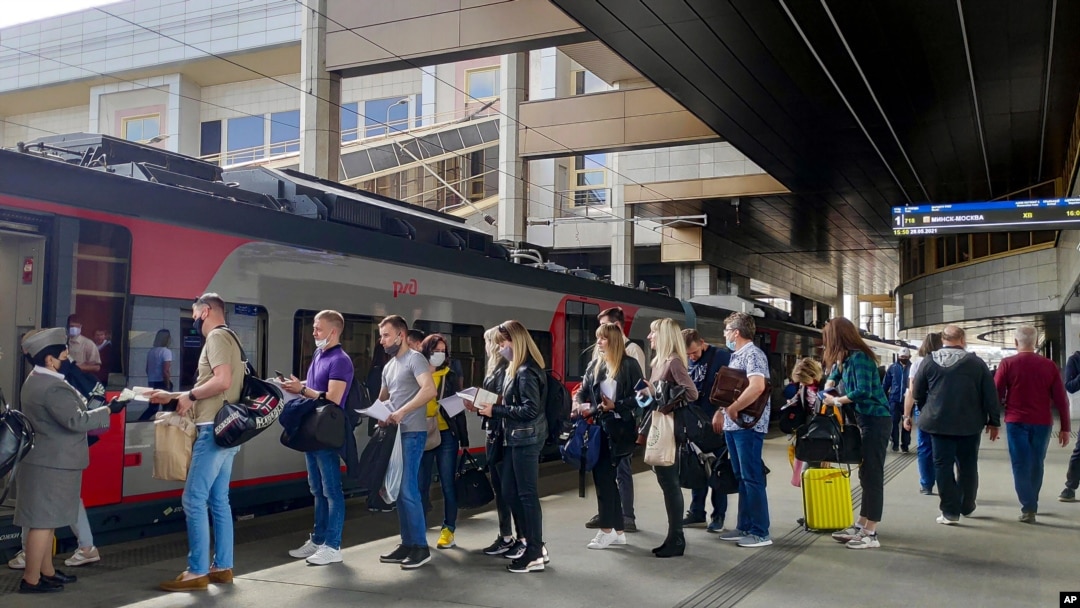 Passengers at a railway station in Minsk, Belarus, stand in line to board a high-speed train to Moscow on May 28, 2021.