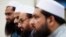 FILE - Hafiz Saeed, second from right, chief of Pakistani religious group Jamaat-ud-Dawa listens to reporters at a news conference in Islamabad, Pakistan, Nov. 2, 2015.