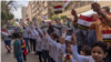 FILE - Egyptian children cheer outside a polling station in downtown Cairo. Egypt’s leaders hoped a high turnout Monday would bolster the poll’s legitimacy, March 26, 2018. (H. Elrasam for VOA)