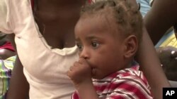 Child in shelter for earthquake survivors in Haiti