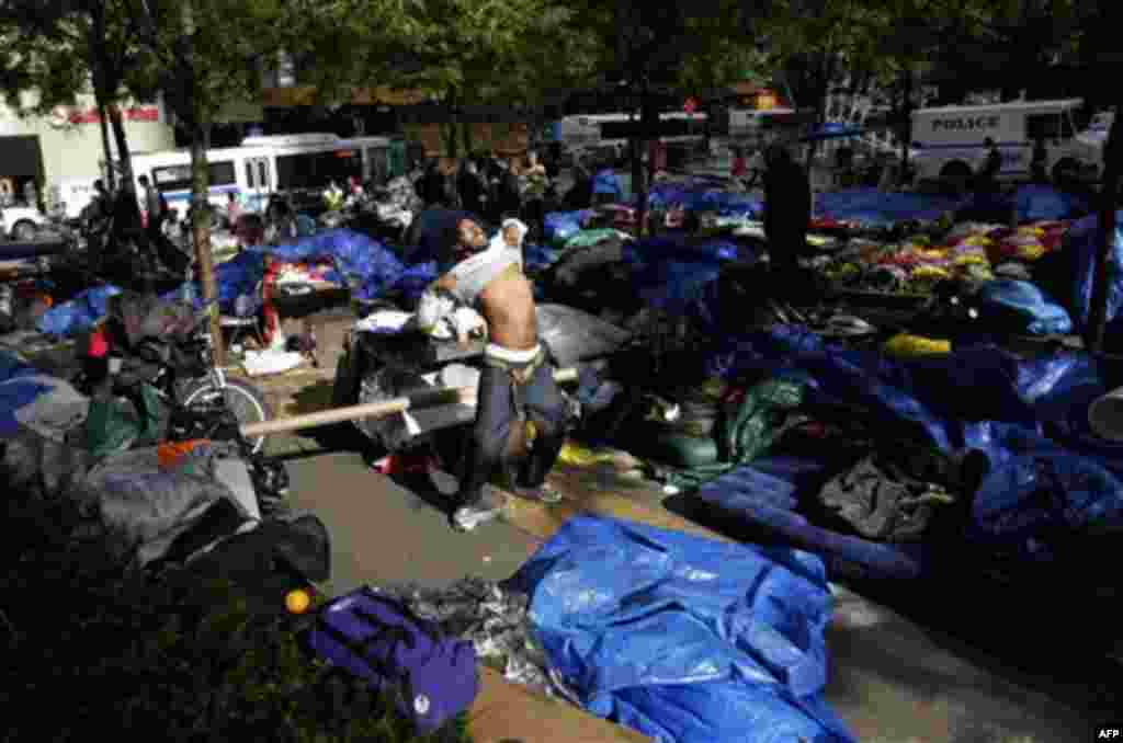 A Occupy Wall Street protester camped in Zuccotti Park tries to catch a little sun on an overcast morning in the financial district in New York, Tuesday, Oct. 4, 2011. The protests have gathered momentum and gained participants in recent days as news of m