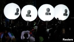Balloons bearing a picture of former South African President Nelson Mandela are seen on Vilakazi Street in Soweto, where Mandela resided when he lived in the township, Dec. 7, 2013.