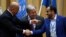 FILE - Head of Houthi delegation Mohammed Abdul-Salam, right, and Yemeni Foreign Minister Khaled al-Yaman, left, shake hands next to U.N. Secretary-General Antonio Guterres during the closing of the Yemen peace talks at the Johannesberg castle in Rimbo, Sweden, Dec. 13, 2018.