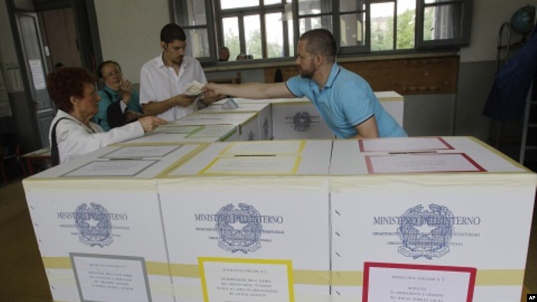 Voters prepare to cast their ballots in Milan, Italy, Sunday, June 12, 2011