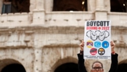 A demonstrator holds a placard as activists demonstrate outside the Colosseum, calling on G20 leaders to boycott the Beijing 2022 Winter Olympics due to China's treatment of Tibet, Uyghur Muslims and Hong Kong. (Yara Nardi/Reuters)