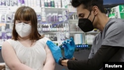 Lauren Borenstein, 16, receives the Pfizer-BioNTech vaccine against the coronavirus disease at Skippack Pharmacy in Schwenksville, Pennsylvania, on March 3, 2021. (Reuters)