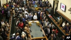 FILE: Members of the House of Assembly sit inside the Zimbabwean Parliament in Harare, Nov. 21 2017. AP Photo/Aaron Ufumeli) 