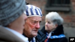 A survivor attends commemorations at the Auschwitz Nazi death camp in Oswiecim, Poland, Monday, Jan. 27, 2020.