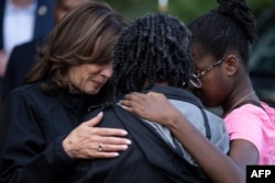 U.S. Vice President Kamala Harris, left, embraces community members as she surveys the damage from Hurricane Helene, in the Meadowbrook neighborhood of Augusta, Georgia, Oct. 2, 2024.