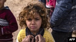A Syrian child stands at the Washukanni camp for internally displaced persons (IDP) in the mainly Kurdish northeastern Syrian province of Hasakeh, Dec. 27, 2019. 