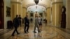 FILE - U.S. senators are seen leaving the Senate chamber on Capitol Hill, in Washington, May 31, 2015.