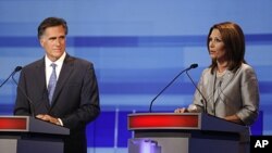 Republican presidential candidates former Massachusetts Gov. Mitt Romney listens to Rep. Michele Bachmann, R-Minn., during the Iowa GOP/Fox News Debate at the CY Stephens Auditorium in Ames, Iowa, Thursday, Aug. 11, 2011