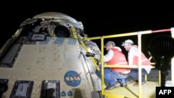 This picture courtesy of NASA taken on Sept. 6, 2024, shows Boeing and NASA teams working around NASA's Boeing Crew Flight Test Starliner spacecraft after it landed without a crew at White Sands, New Mexico.