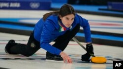 Stefania Constantini of Italy throws a last rock before a win against Norway during the mixed doubles gold medals curling match at the Beijing Winter Olympics, Feb. 8, 2022.