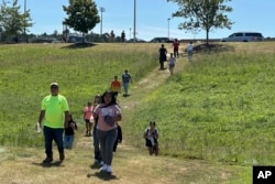 People leave Apalachee High School after a shooting at the school, Sept. 4, 2024, in Winder, Georgia.