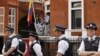 Surrounded by British police officers WikiLeaks founder Julian Assange, center, makes a statement to the media and supporters 