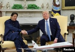 Pakistan’s Prime Minister Imran Khan shakes hands with U.S. President Donald Trump at the start of their meeting in the Oval Office of the White House in Washington, July 22, 2019.