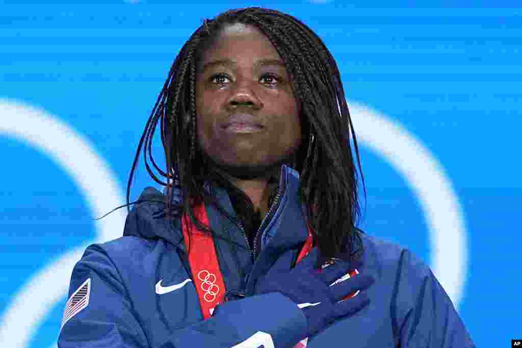 Gold Medalist Erin Jackson of the United States stands for her national anthem during the medal ceremony for the speedskating women&#39;s 500-meter race at the 2022 Winter Olympics in Beijing.