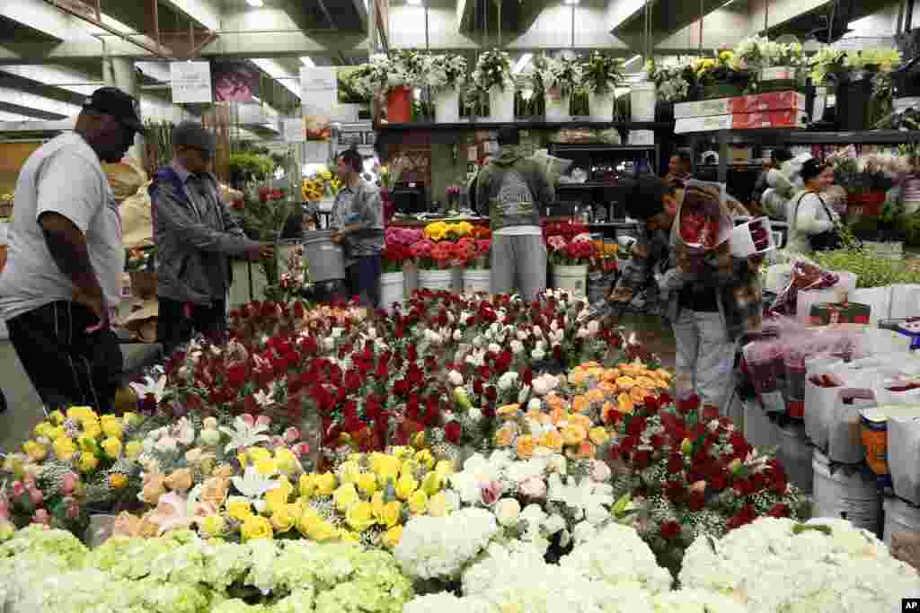 Buyers at the Flower Market look at Valentine&#39;s Day flowers for purchase in Los Angeles, California.