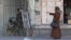 A woman gestures at Israeli security forces firing rubber-bullets to disperse Palestinian stone-throwers amid clashes in the West Bank town of Hebron.