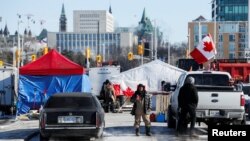 Truckers and supporters continue to protest coronavirus disease (COVID-19) vaccine mandates from the camp at the Canadian War Museum, in Ottawa, Ontario, Canada, Feb. 14, 2022.