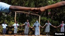 Sitienei enjoys singing games with her classmates, January 25, 2022. REUTERS/Monicah Mwangi