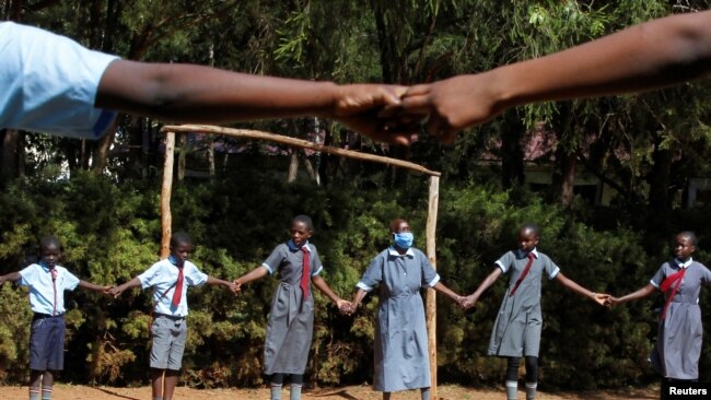 Sitienei enjoys singing games with her classmates, January 25, 2022. REUTERS/Monicah Mwangi