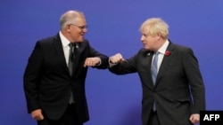 FILE - Britain's Prime Minister Boris Johnson greets Australia's Prime Minister Scott Morrison at the COP26 climate conference in Glasgow, Scotland, Nov. 1, 2021. On Feb. 16, 2022, Britain committed $34 million to strengthen Indo-Pacific security.
