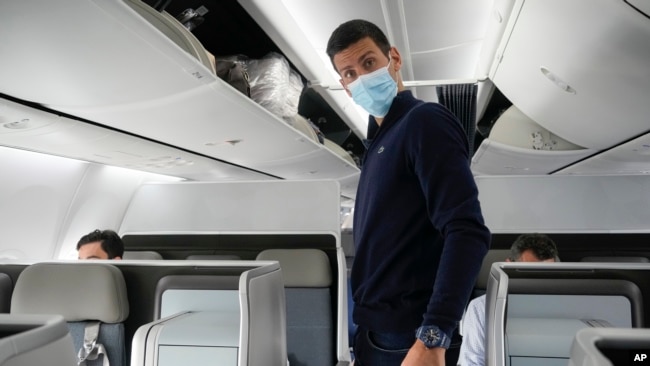 Novak Djokovic prepares to take his seat on a plane to Belgrade, in Dubai, United Arab Emirates, Monday, Jan. 17, 2022. (AP Photo/Darko Bandic, FILE)