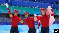 Team Norway's Peder Kongshaug, left, Sverre Lunde Pedersen, center, and Hallgeir Engebraaten celebrate after they won the gold medal in the speedskating men's team pursuit finals at the 2022 Winter Olympics, Tuesday, Feb. 15, 2022.