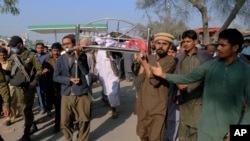 Relatives carry the body of Mushtaq Ahmed, 41, who was killed when an enraged mob stoned him to death for allegedly desecrating the Quran, in Tulamba, a remote village in the district of Khanewal in eastern Pakistan, Feb. 13, 2022.