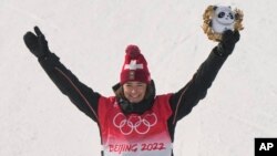 Gold medal winner Switzerland's Mathilde Gremaud celebrates during the venue award ceremony for the women's slopestyle finals at the 2022 Winter Olympics, Feb. 15, 2022, in Zhangjiakou, China.