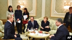 FILE - From left, Russian President Vladimir Putin, French President Francois Hollande, German Chancellor Angela Merkel and Ukrainian President Petro Poroshenko talk in Minsk, Belarus, Feb. 11, 2015.