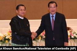 FILE - Cambodian Prime Minister Hun Sen, right, shakes hands with Myanmar State Administration Council Chairman, Senior General Min Aung Hlaing, left, during after a meeting in Naypyitaw, Myanmar, Jan. 7, 2022.