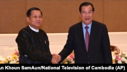 FILE - Cambodian Prime Minister Hun Sen, right, shakes hands with Myanmar State Administration Council Chairman, Senior General Min Aung Hlaing, left, during after a meeting in Naypyitaw, Myanmar, Jan. 7, 2022. (An Khoun SamAun/National Television of Cambodia via AP,)