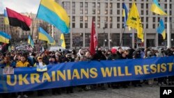 Ukrainians attend a rally in central Kyiv, Ukraine, Saturday, Feb. 12, 2022, during a protest against the potential escalation of the tension between Russia and Ukraine. (AP Photo/Efrem Lukatsky)