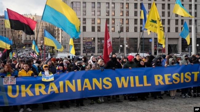 Ukrainians attend a rally in central Kyiv, Ukraine, Saturday, Feb. 12, 2022, during a protest against the potential escalation of the tension between Russia and Ukraine. (AP Photo/Efrem Lukatsky)