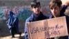 Afghan protesters hold placards and shout slogans against US during a protest condemning President Joe Biden's decision, in Kabul, Afghanistan, Feb. 12, 2022. 