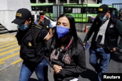 FILE - Lawyer Leily Santizo, former head of U.N.-backed anti-corruption commission CICIG (International Commission against Impunity in Guatemala), is escorted by police at the Supreme Court of Justice building in Guatemala City, Guatemala, Feb. 10, 2022.