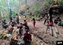 FILE - Displaced people from Mindat take shelter in a forest in western Myanmar's Chin state, amid ongoing attacks by the military following clashes with the Chin Defence Forces militia group, in May 2021. (Handout photo by Chin World / AFP)