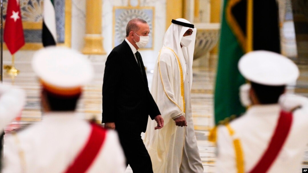 Turkish President Recep Tayyip Erdogan, left, and Abu Dhabi Crown Prince Sheikh Mohammed bin Zayed Al Nahyan look over an honor guard at Qasr Al-Watan in Abu Dhabi, United Arab Emirates, Feb. 14, 2022. 
