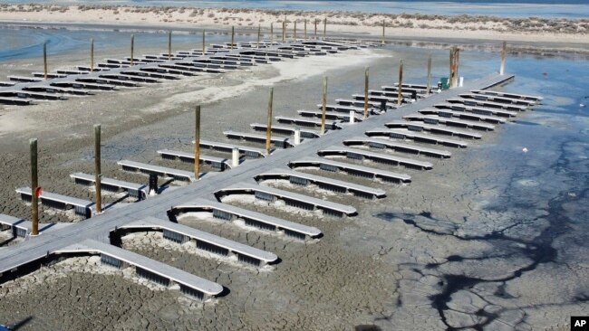 Mud surrounds the boat dock Saturday, Jan. 29, 2022, at Antelope Island, Utah. (AP Photo/Rick Bowmer)