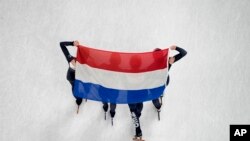 Team Netherlands celebrate after winning the women&#39;s 3000-meter relay final during the short track speedskating competition at the 2022 Winter Olympics in Beijing.