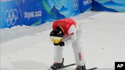 China's Qi Guangpu reacts during the men's aerials finals at the 2022 Winter Olympics, Feb. 16, 2022, in Zhangjiakou, China.