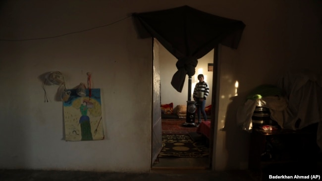 Roza Barakat poses for a portrait in a safe house in Hassakeh, Syria, Sunday, Feb. 6, 2022. (AP Photo/Baderkhan Ahmad)