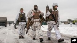 Ukrainian soldiers walk during military drills near Kharkiv, Ukraine, close to the country's border with Russia, Feb. 10, 2022.